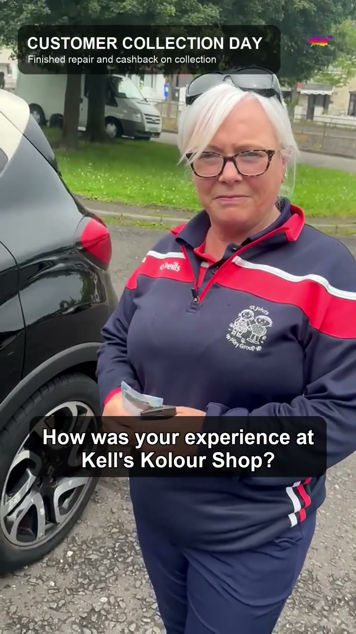 Customer beside her repaired car after collection